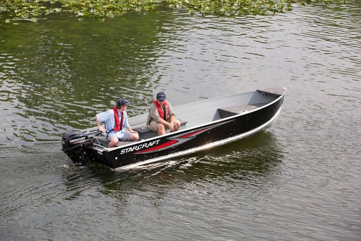 a group of people in a small boat in a body of water