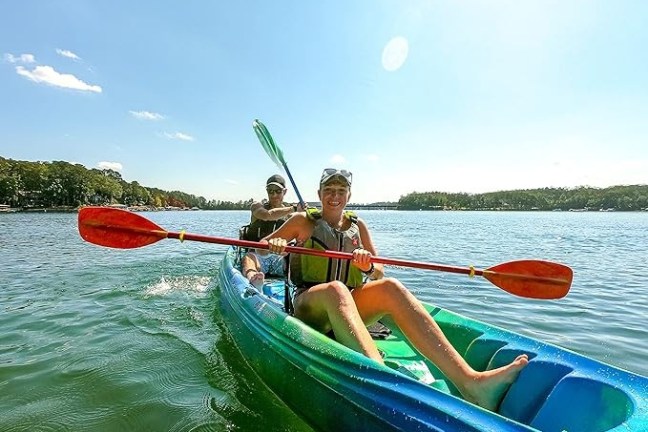 a group of people in a small boat in a body of water