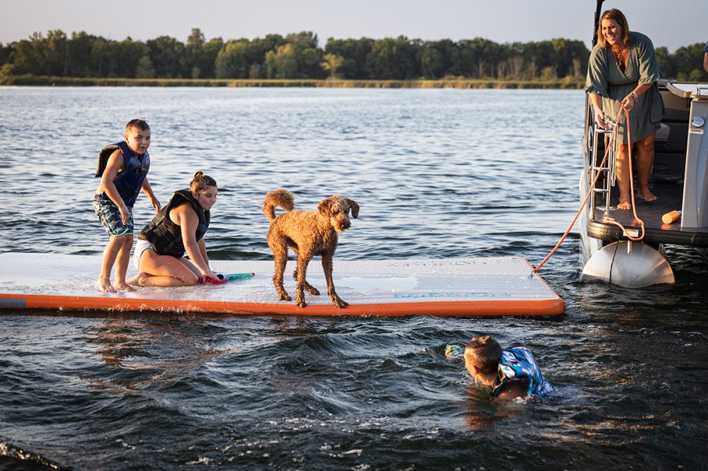 a group of people riding on the back of a boat in the water